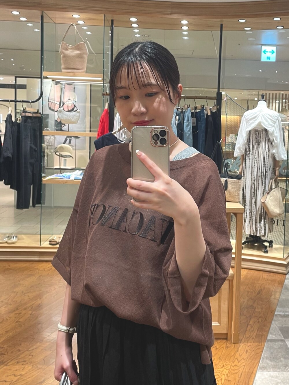 ブラック系のスカート、ブラック系のパンプス、ブラウン系のニット/セーターを着用したレディースの夏コーディネートの2枚目の写真