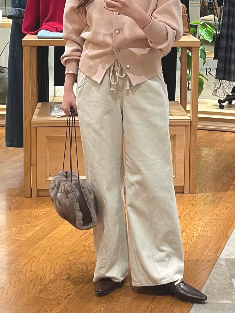 ピンク系のカーディガン/ボレロ、ホワイト系のデニムパンツ、ブラウン系のその他シューズを着用したレディースの秋コーディネートの3枚目の写真