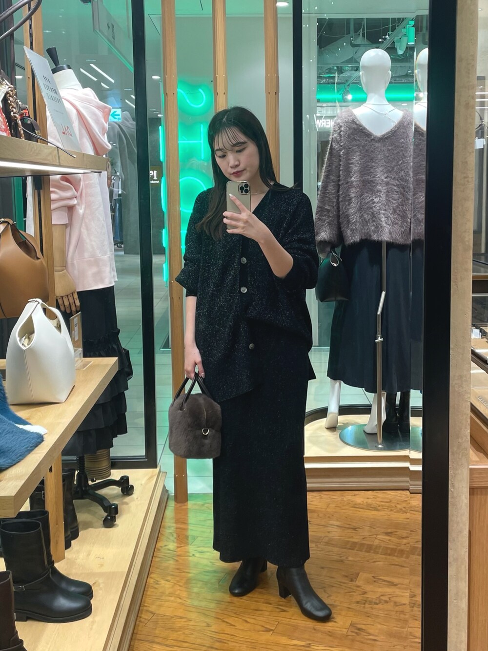 ブラック系のニット/セーター、ブラック系のブーツ、ブラック系のスカートを着用したレディースの冬コーディネートの3枚目の写真