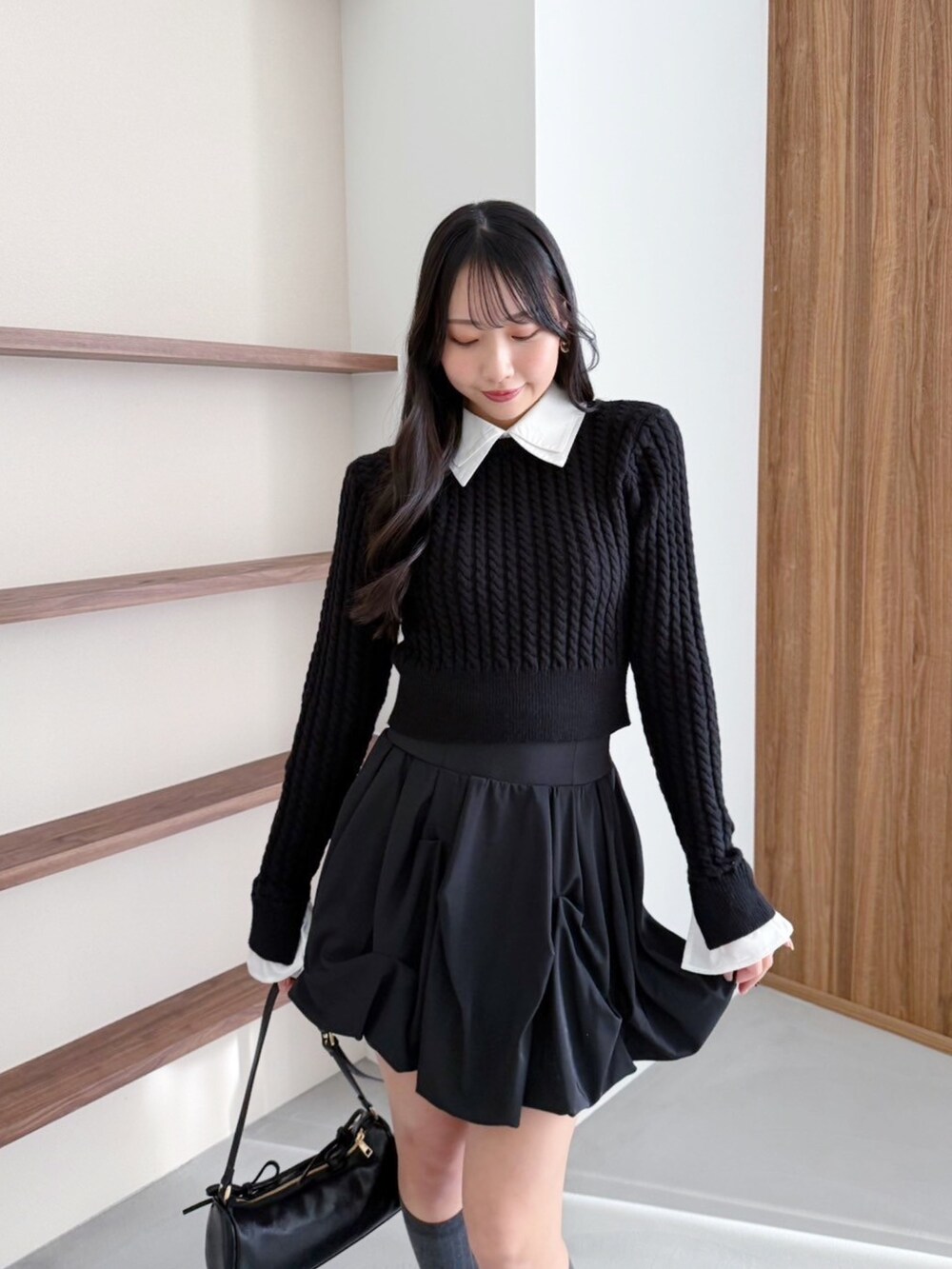 ブラック系のスカート、ブラック系のニット/セーターを着用したレディースの冬コーディネートの3枚目の写真