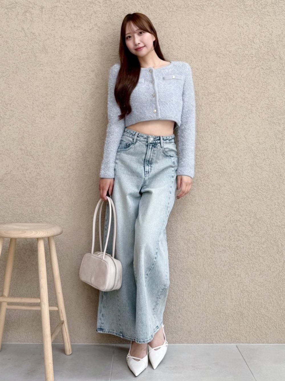 ブルー系のデニムパンツ、グレー系のノーカラージャケットを着用したレディースの秋コーディネートの2枚目の写真