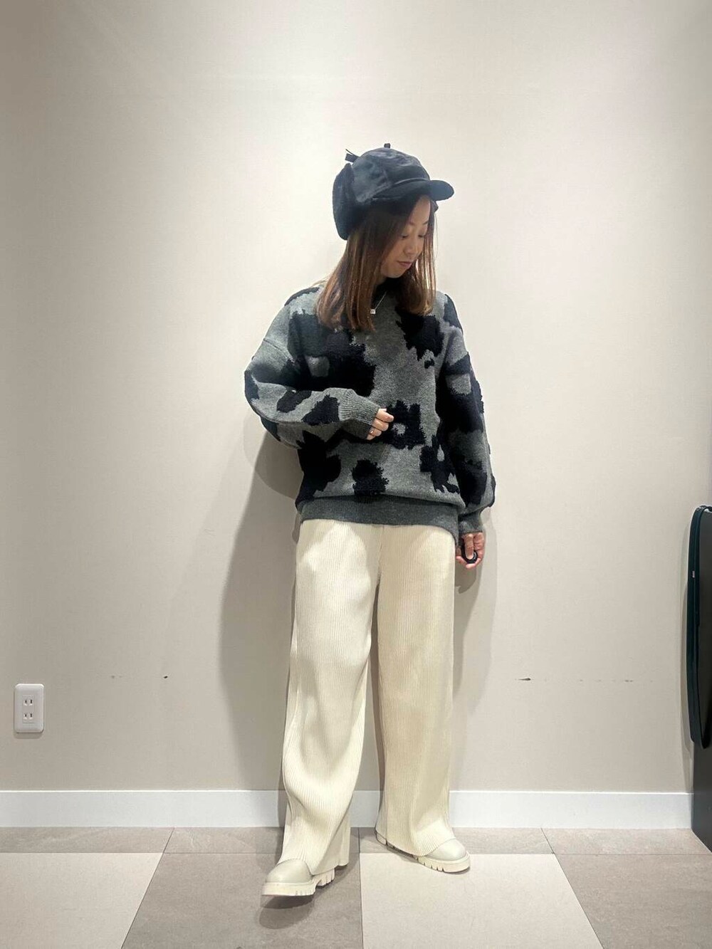 ホワイト系のその他パンツ、ブラック系のダウンジャケット/コート、グレー系のニット/セーターを着用したレディースの冬コーディネートの4枚目の写真