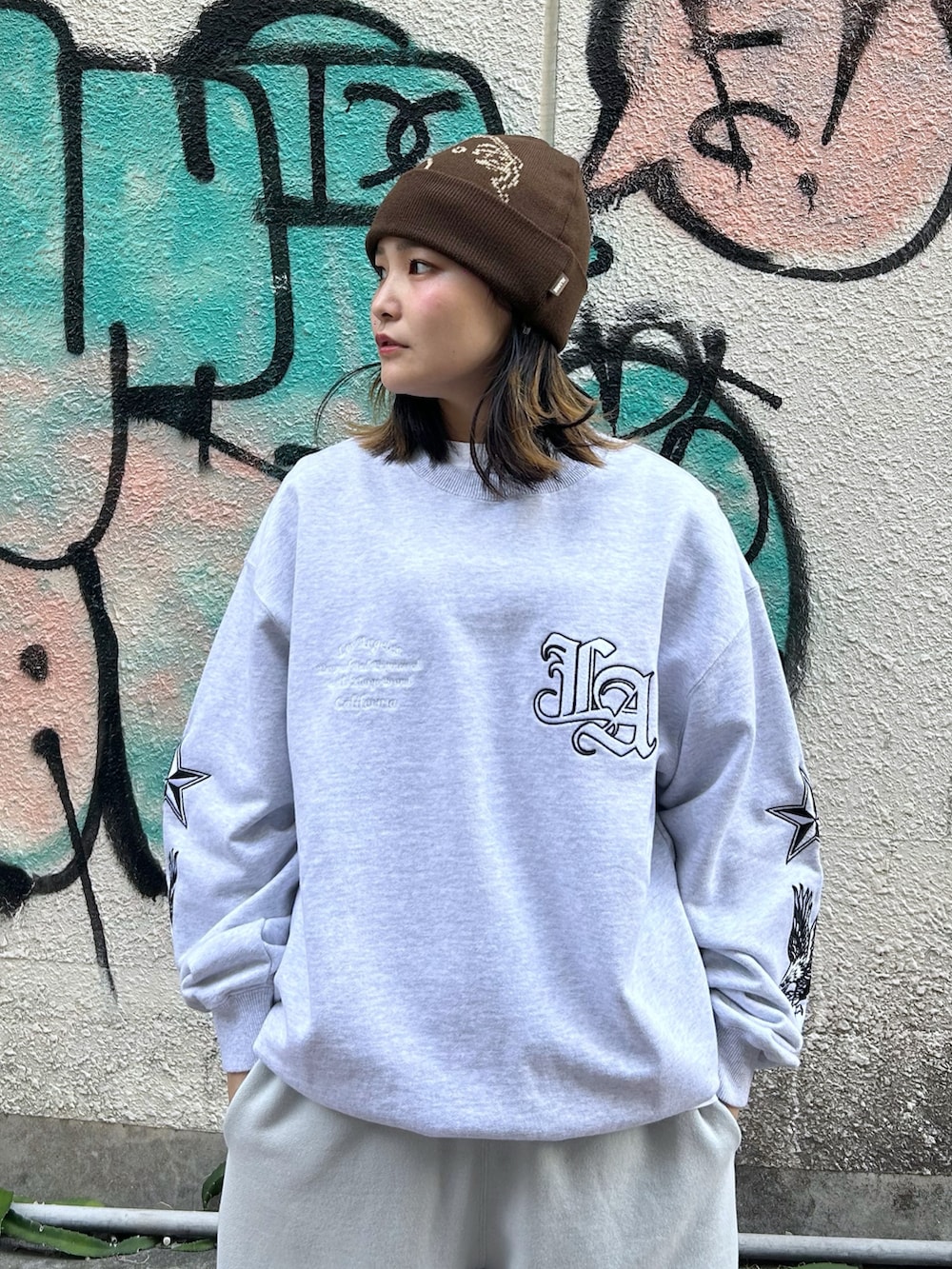 ブルー系のダウンベスト、グレー系のスウェット、グレー系のスウェットパンツを着用したレディースの秋コーディネートの5枚目の写真