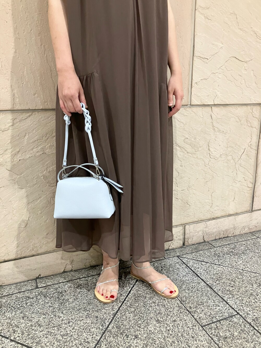 ブラウン系のワンピース、ブルー系のショルダーバッグ、シルバー系のサンダルを着用したレディースの夏コーディネートの5枚目の写真