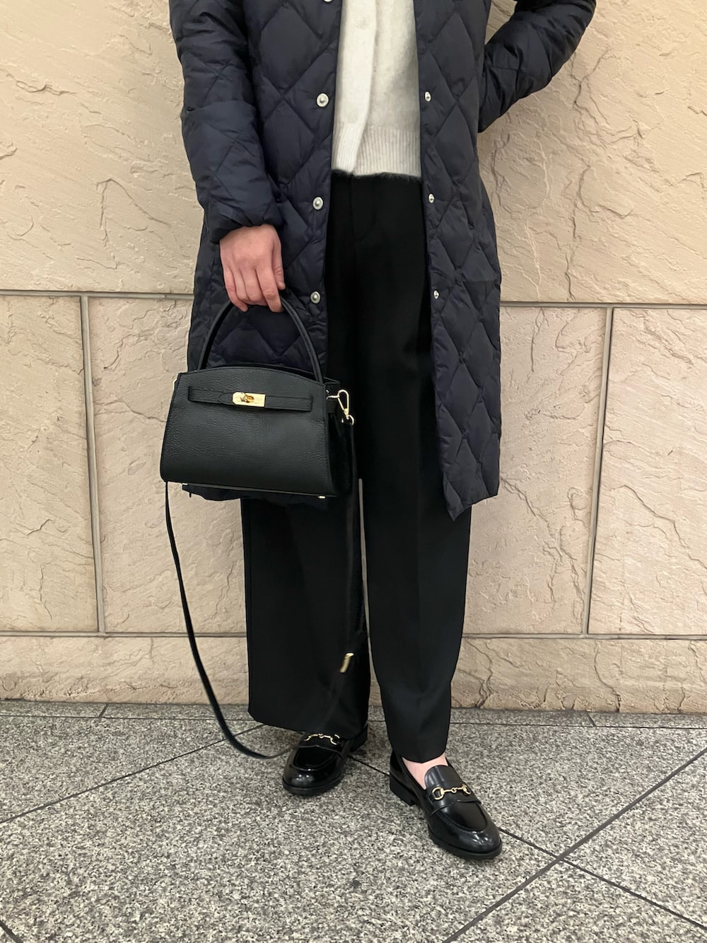 ホワイト系のカーディガン/ボレロ、ブラック系のパンツ、ブラック系のバッグを着用したレディースの秋コーディネートの5枚目の写真