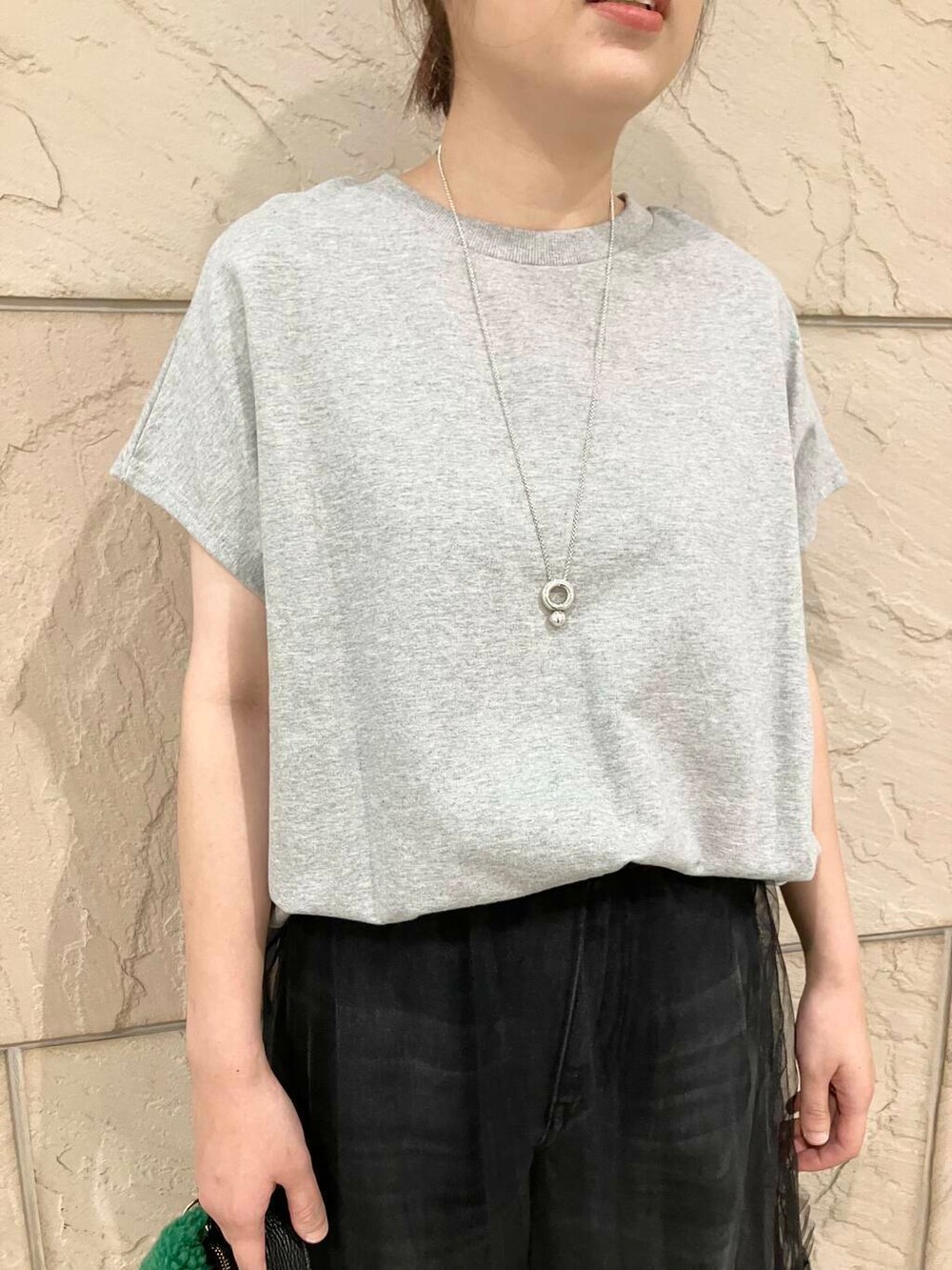 グレー系のTシャツ/カットソー、グレー系のデニムパンツ、ブラック系のスカートを着用したレディースの夏コーディネートの6枚目の写真