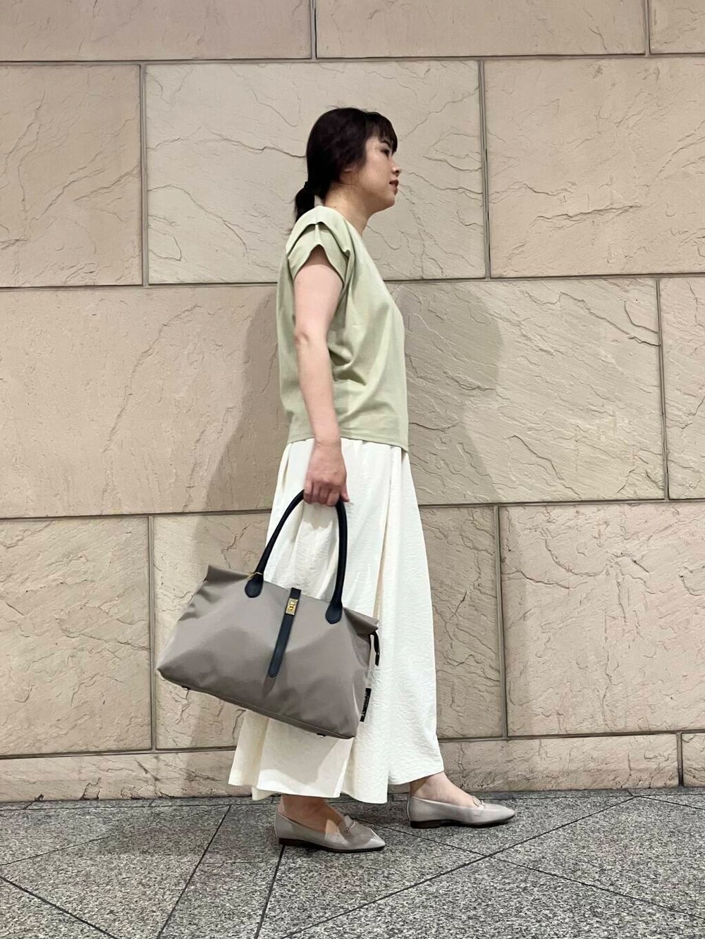 グレー系のローファー、ホワイト系のその他パンツ、グリーン系のTシャツ/カットソーを着用したレディースの夏コーディネートの2枚目の写真