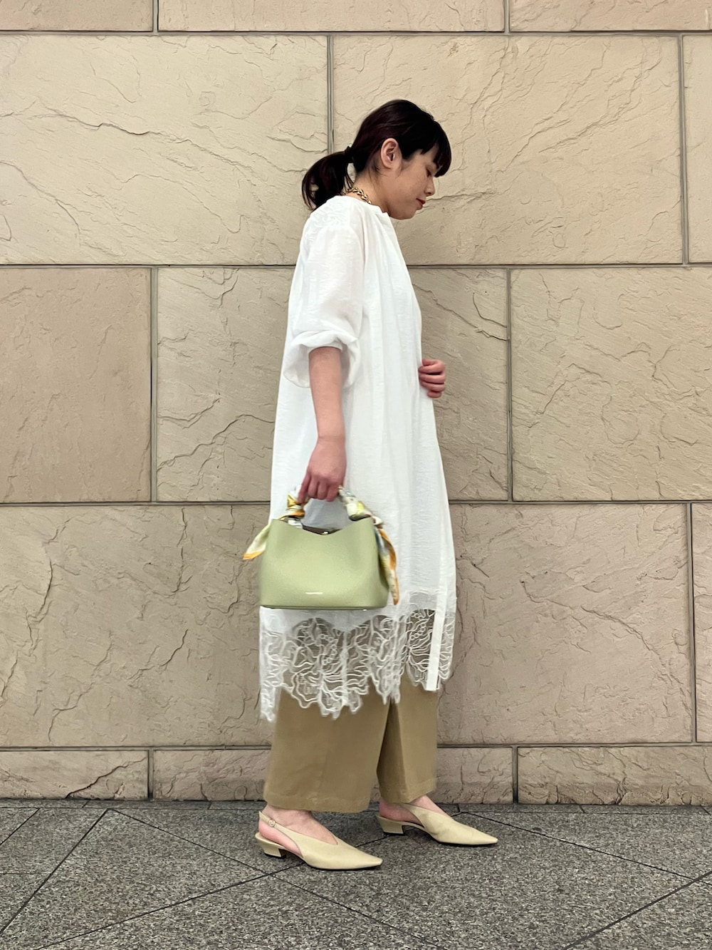 ベージュ系のその他パンツ、ホワイト系のワンピース、グリーン系のバッグを着用したレディースの春コーディネートの2枚目の写真