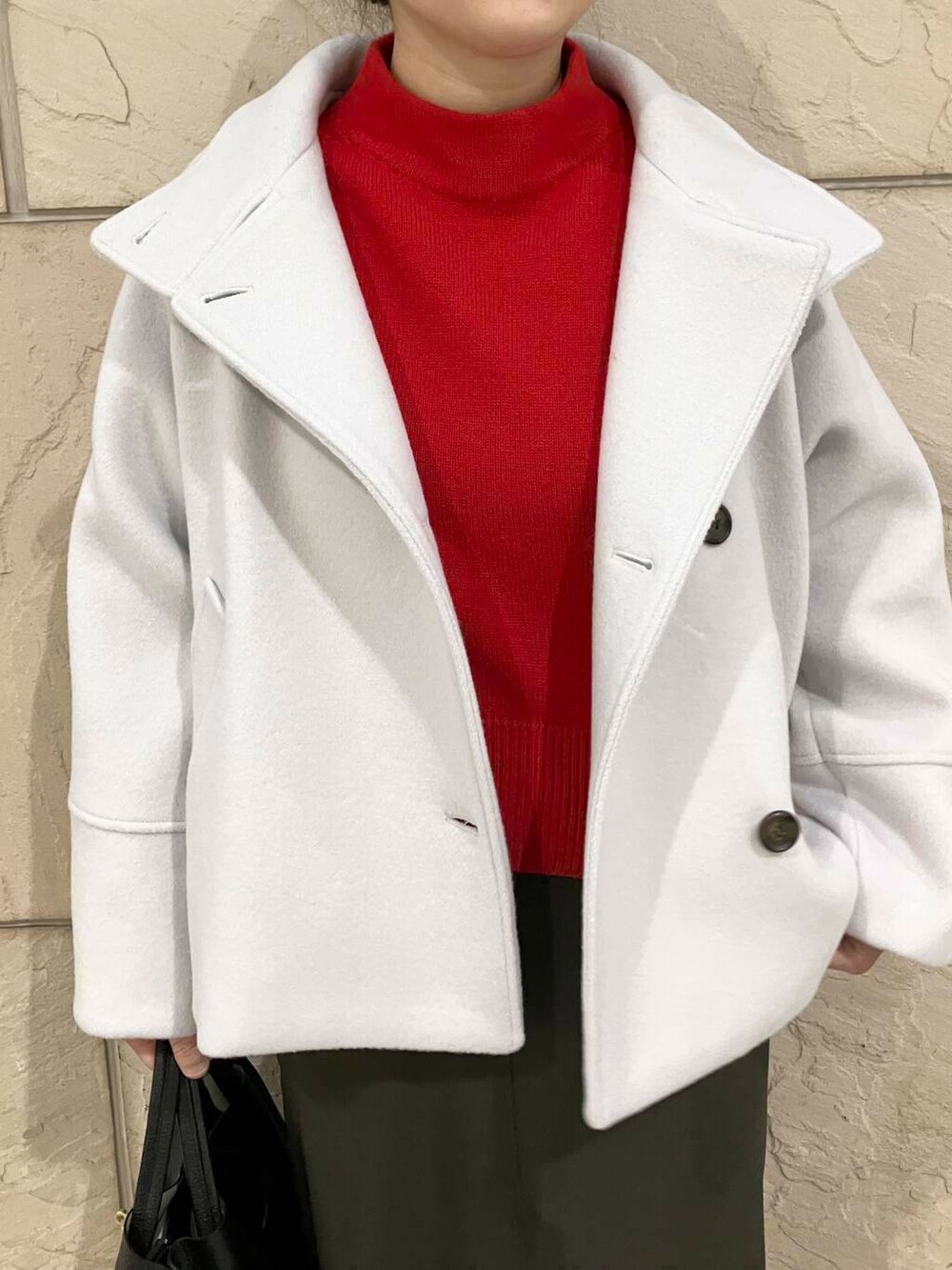 グリーン系のスカート、グレー系のピーコート、ブラック系のブーツを着用したレディースの冬コーディネートの4枚目の写真