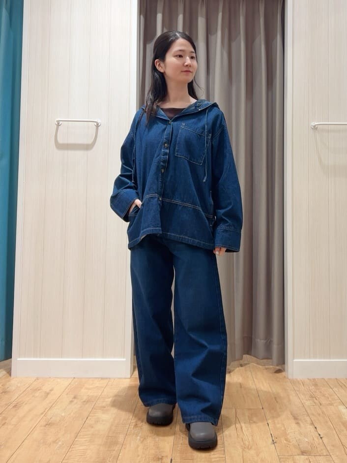 ブルー系のデニムジャケット、ブラウン系のTシャツ/カットソー、ブルー系のデニムパンツを着用したレディースの秋コーディネートの3枚目の写真