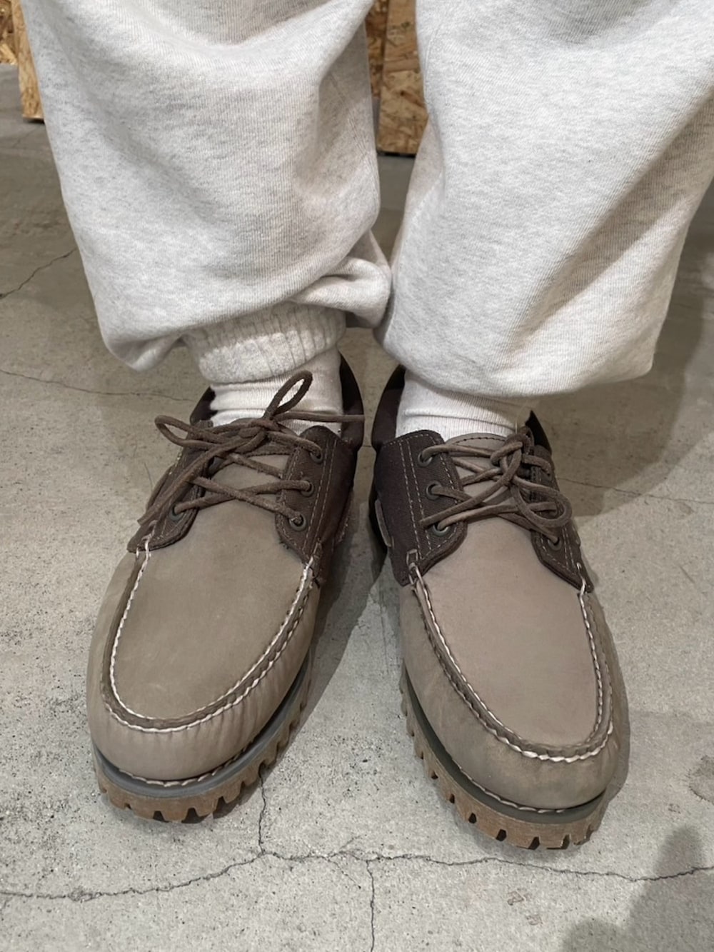 グリーン系のミリタリージャケット、グレー系のシューズ、ホワイト系のスウェットパンツを着用したメンズの春コーディネートの3枚目の写真