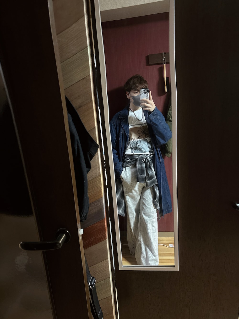 ブルー系のステンカラーコート、ホワイト系のデニムパンツ、ブラック系のシャツ/ブラウスを着用したメンズの春コーディネートの2枚目の写真