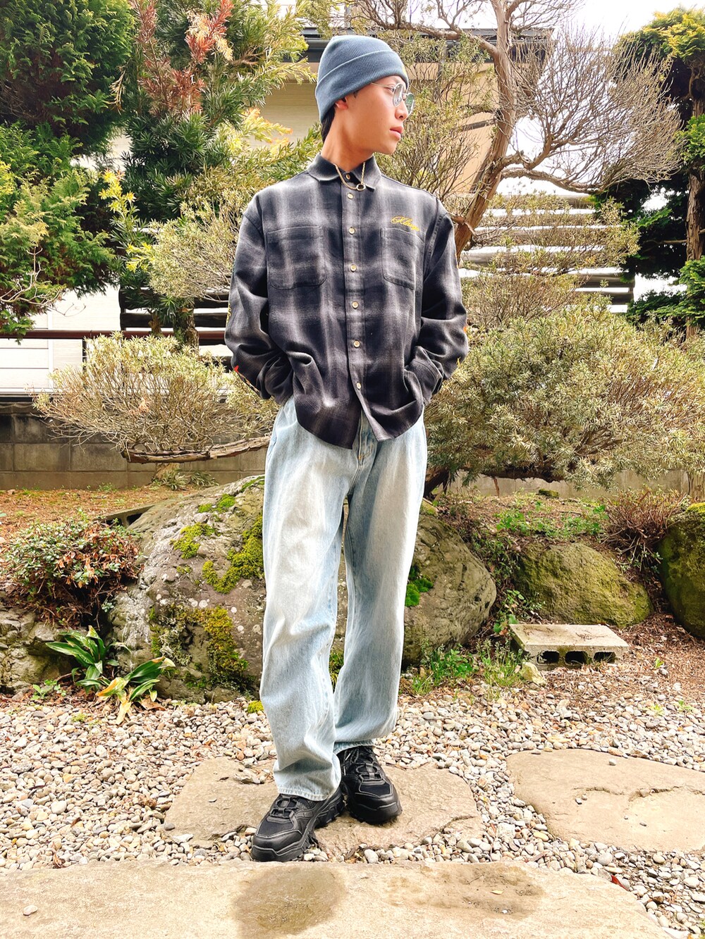 ブラック系のシャツ/ブラウス、ブルー系のデニムパンツ、ブラック系のスニーカーを着用したメンズの春コーディネートの2枚目の写真