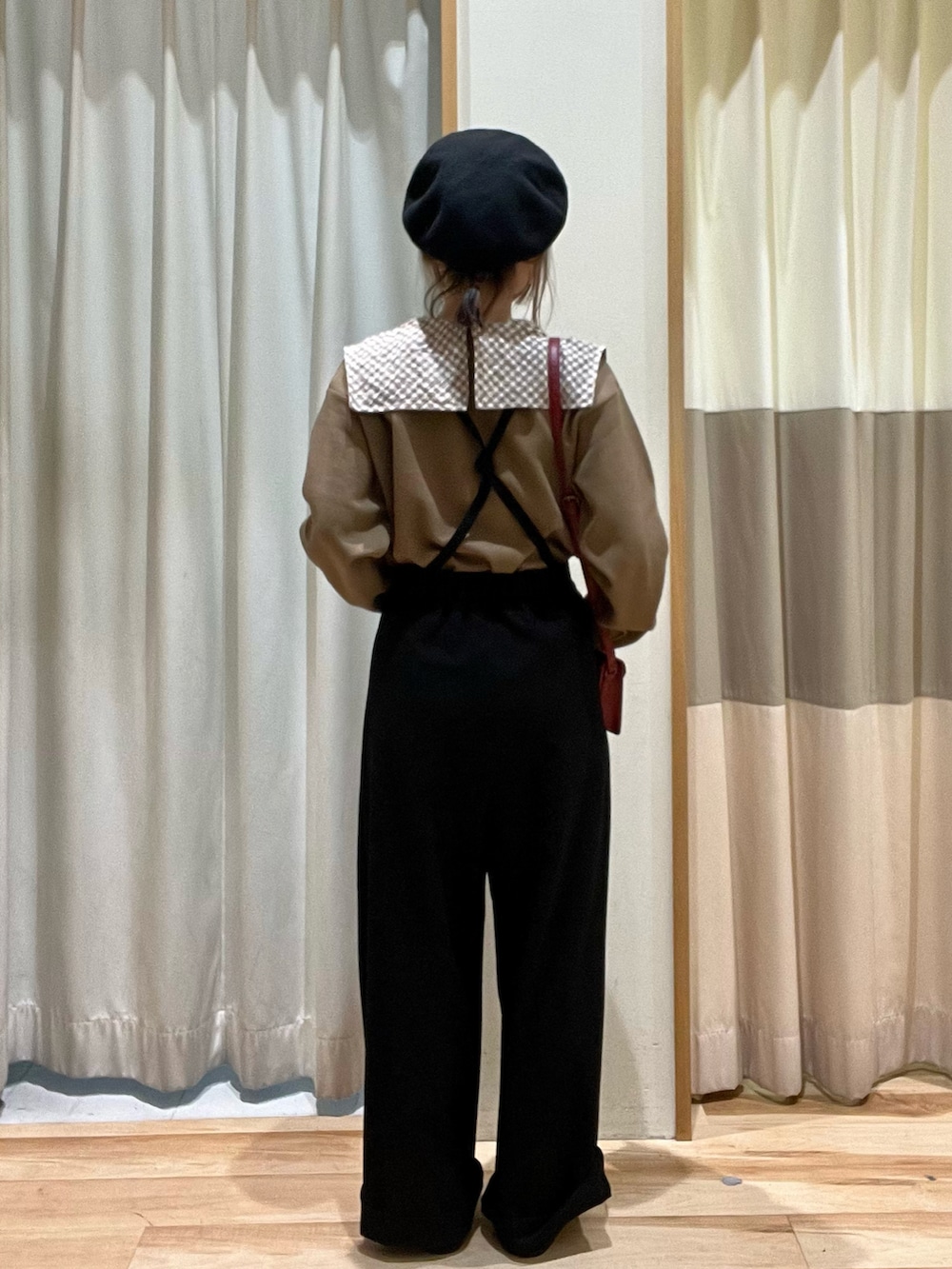 ベージュ系のTシャツ/カットソー、レッド系のショルダーバッグ、ブラック系のその他パンツを着用したレディースの秋コーディネートの3枚目の写真