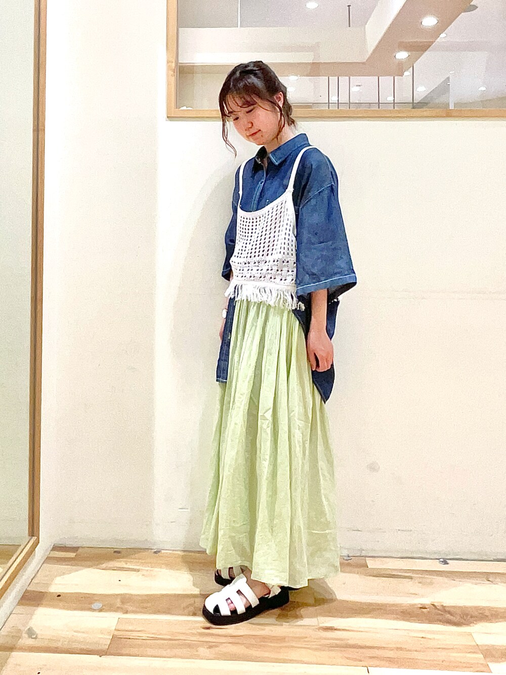 ブルー系のシャツ/ブラウス、ホワイト系のニット/セーター、グリーン系のその他パンツを着用したレディースの春コーディネートの2枚目の写真