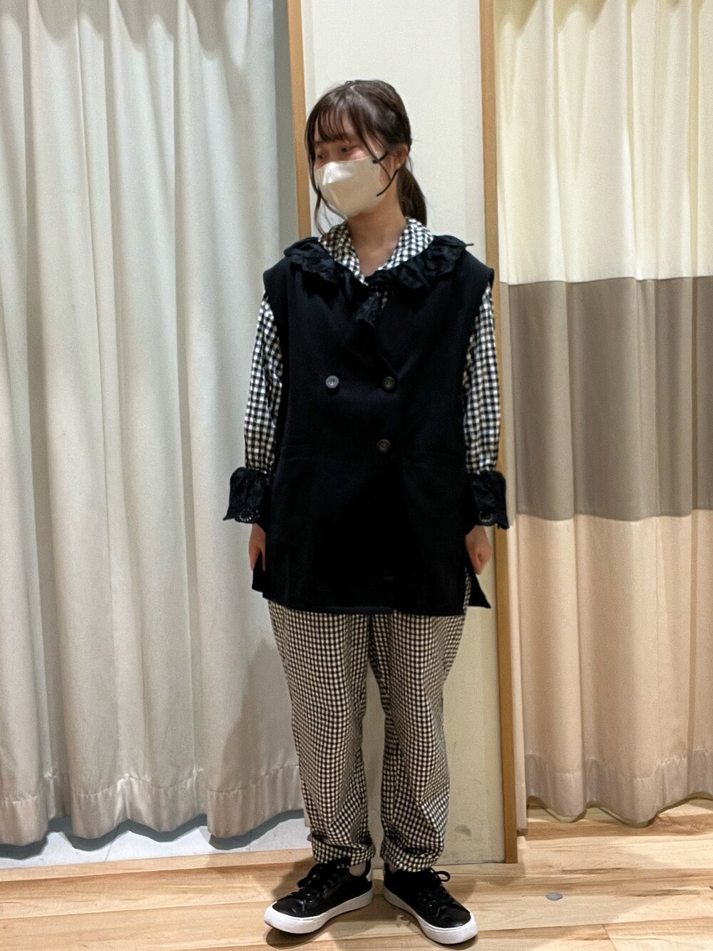 グレー系のシャツ/ブラウス、ブラック系のベスト、ホワイト系のその他パンツを着用したレディースの春コーディネートの2枚目の写真