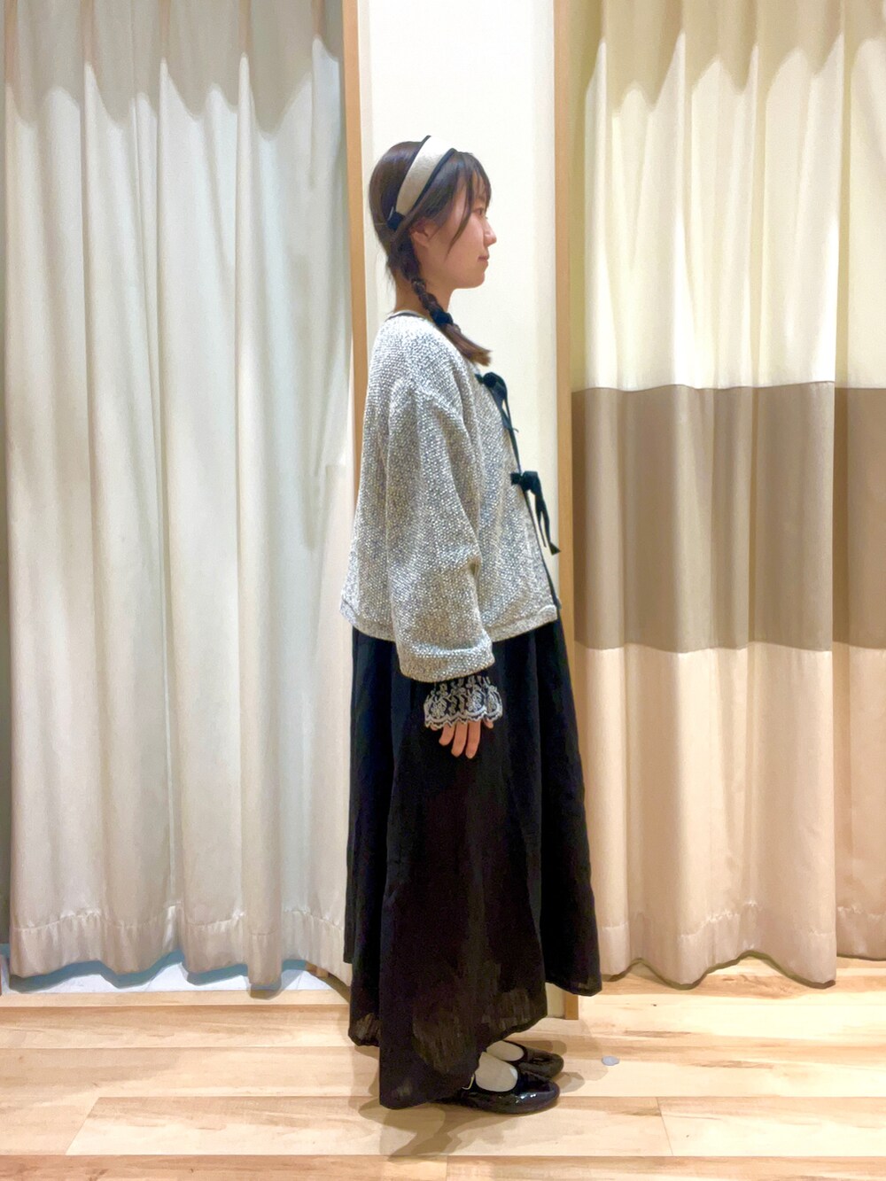 ブラック系のワンピース、ブラック系のノーカラージャケット、ベージュ系のネックレスを着用したレディースの秋コーディネートの2枚目の写真