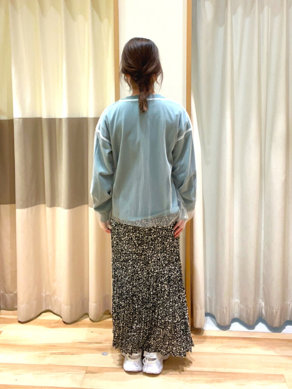 ブラック系のスカート、ホワイト系のTシャツ/カットソー、グリーン系のTシャツ/カットソーを着用したレディースの春コーディネートの3枚目の写真