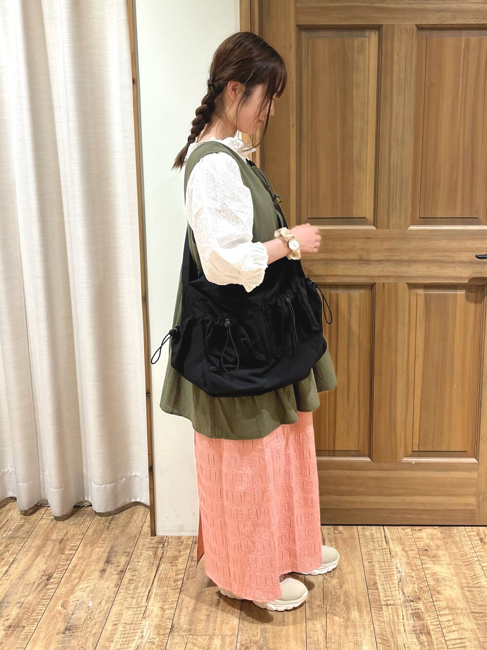 ベージュ系のドレスシューズ、レッド系のスカート、ブラック系のハンドバッグを着用したレディースの秋コーディネートの5枚目の写真