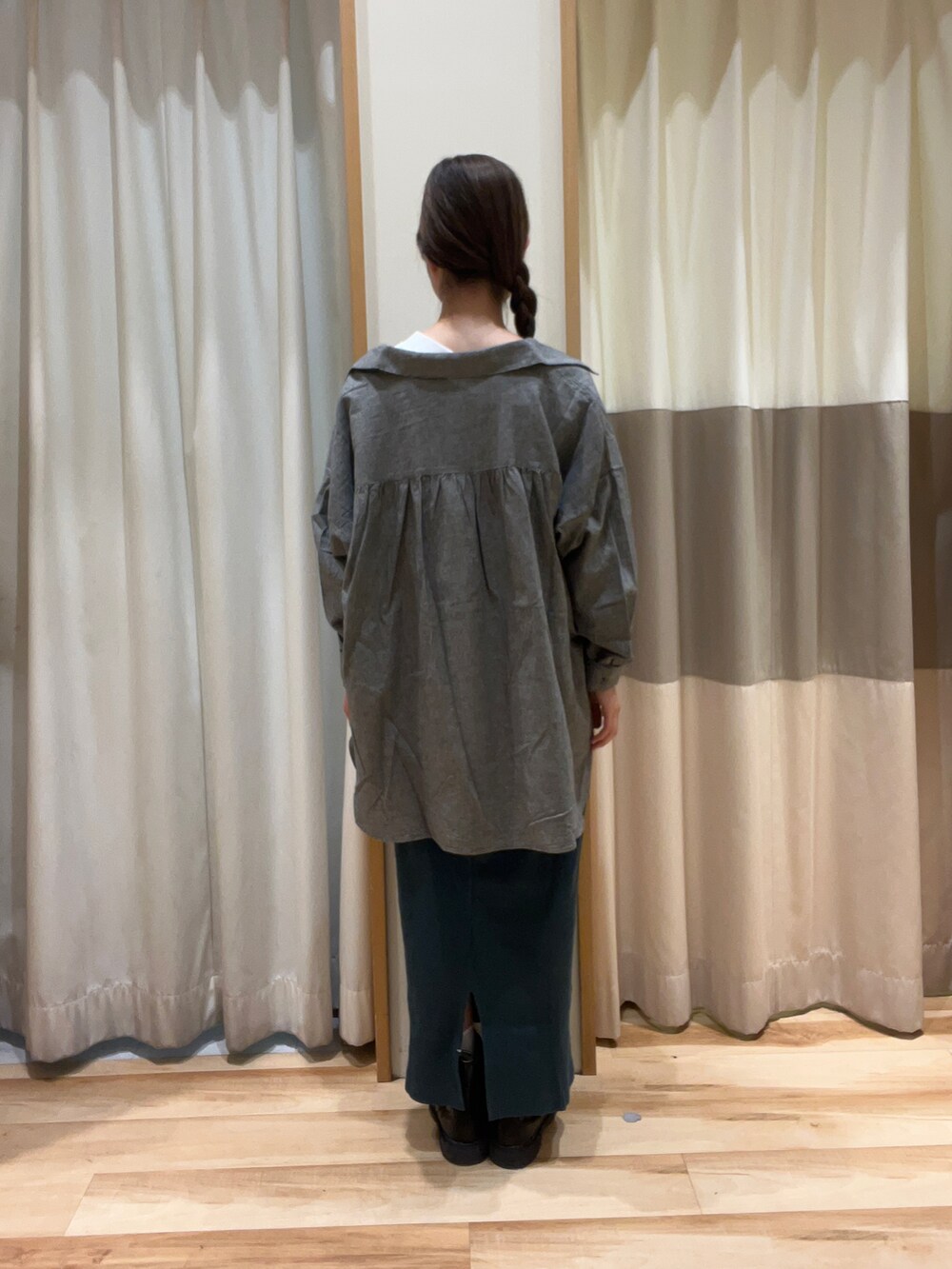 ホワイト系のTシャツ/カットソー、ブラック系のハンドバッグ、グリーン系のスカートを着用したレディースの秋コーディネートの3枚目の写真