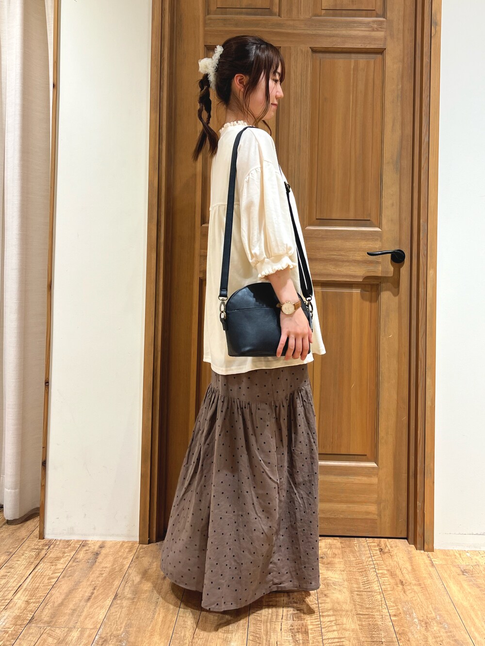 ブラック系のハンドバッグ、グレー系のワンピース、ホワイト系のTシャツ/カットソーを着用したレディースの夏コーディネートの2枚目の写真