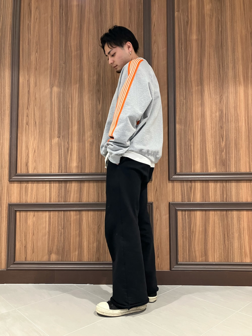 オレンジ系のスウェット、ブラック系のスウェットパンツを着用したメンズの冬コーディネートの2枚目の写真