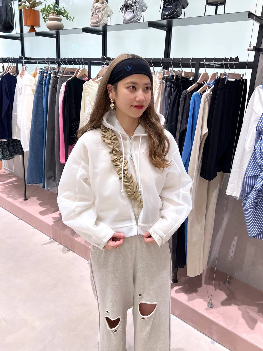 グレー系のスウェットパンツ、ホワイト系のニット/セーター、ホワイト系のパーカーを着用したレディースの冬コーディネートの3枚目の写真