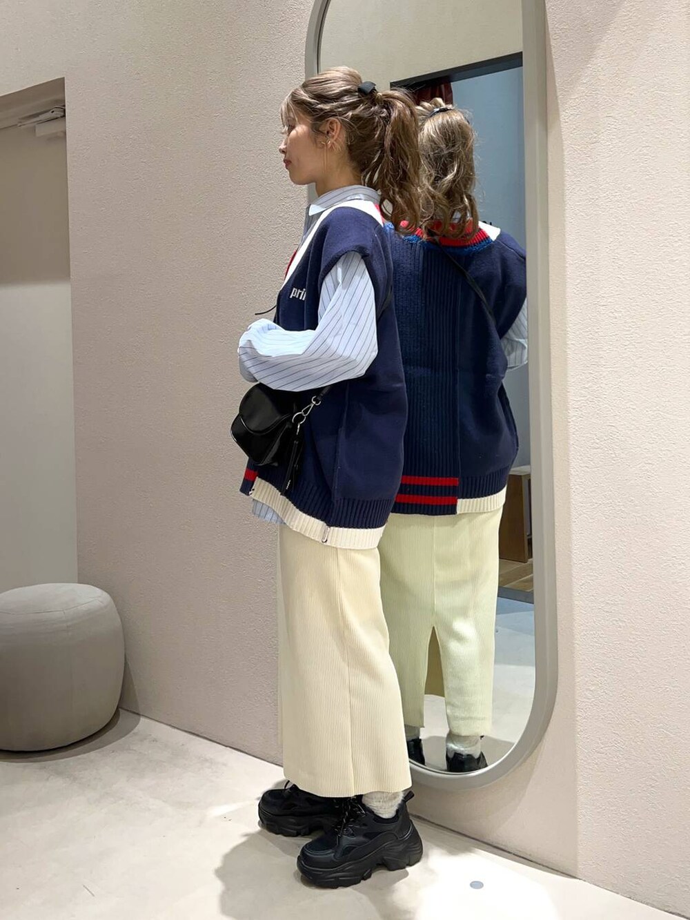 ブルー系のシャツ/ブラウス、ブラック系のスニーカー、ブラック系のショルダーバッグを着用したレディースの冬コーディネートの2枚目の写真