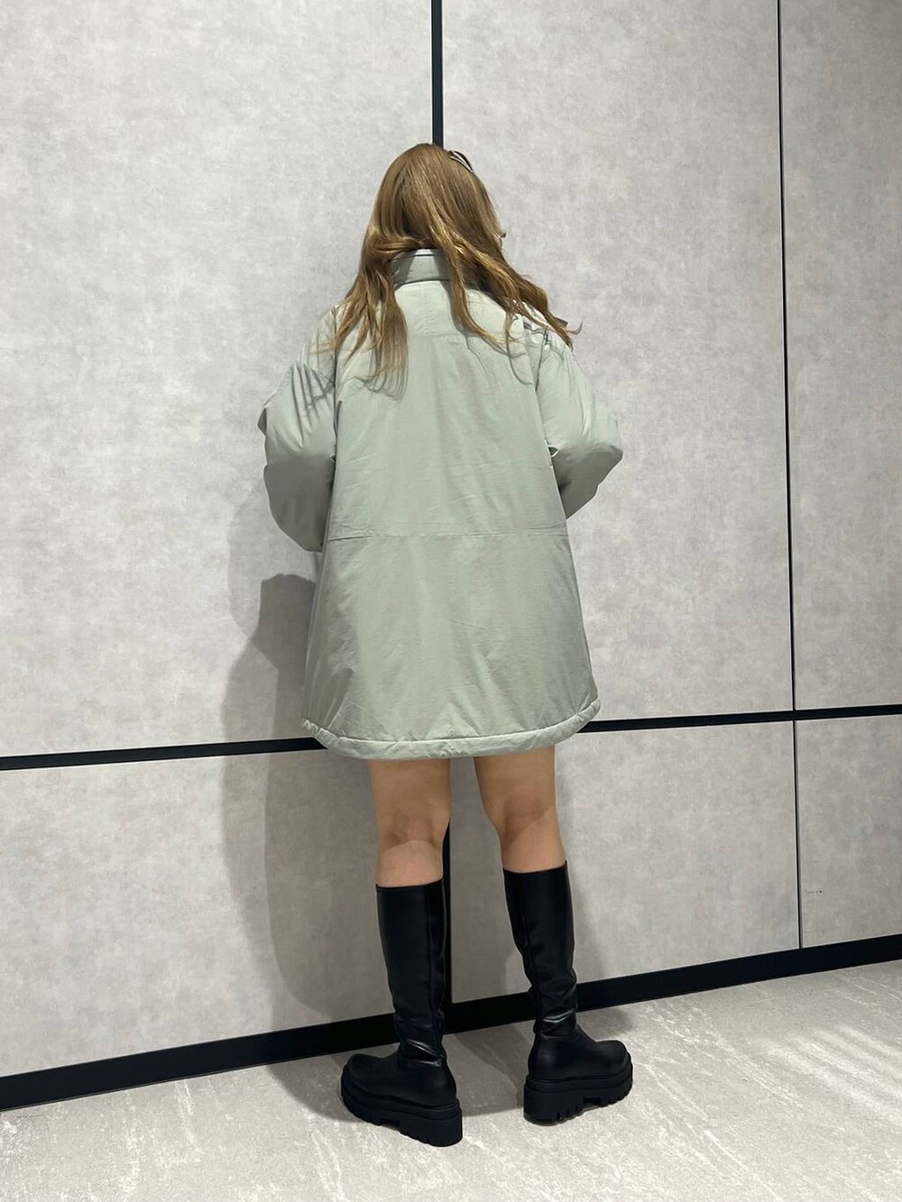 ブラック系のその他パンツ、グリーン系のダウンジャケット/コート、ブラック系のブーツを着用したレディースの冬コーディネートの3枚目の写真