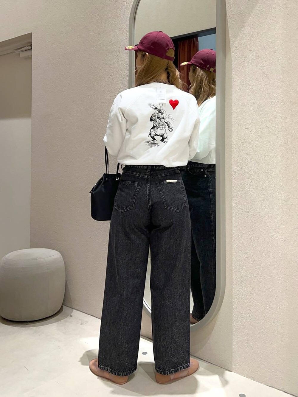 ブラック系のハンドバッグ、ブラウン系のTシャツ/カットソー、ピンク系のスニーカーを着用したレディースの冬コーディネートの3枚目の写真