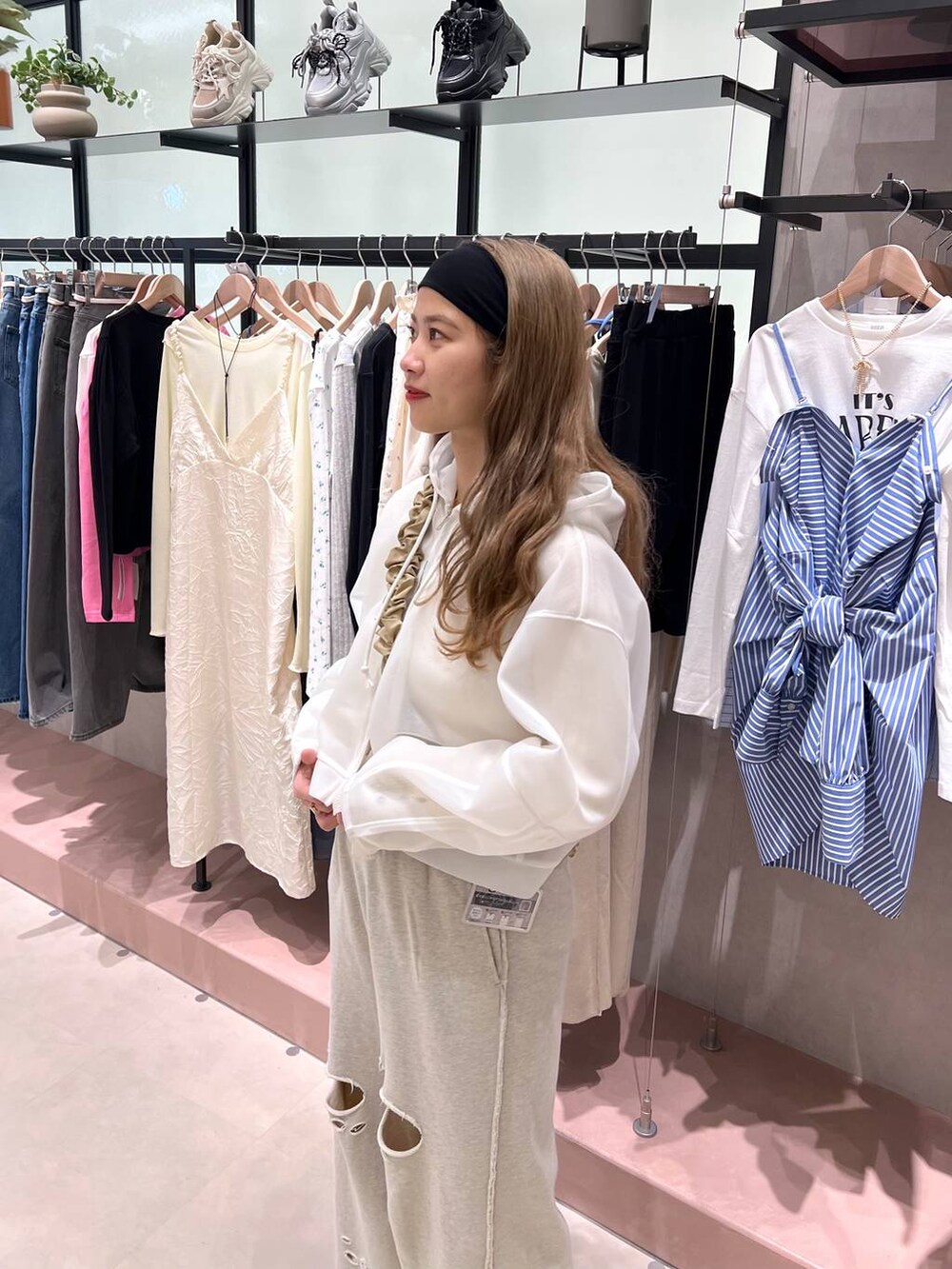 グレー系のスウェットパンツ、ホワイト系のニット/セーター、ホワイト系のパーカーを着用したレディースの冬コーディネートの2枚目の写真