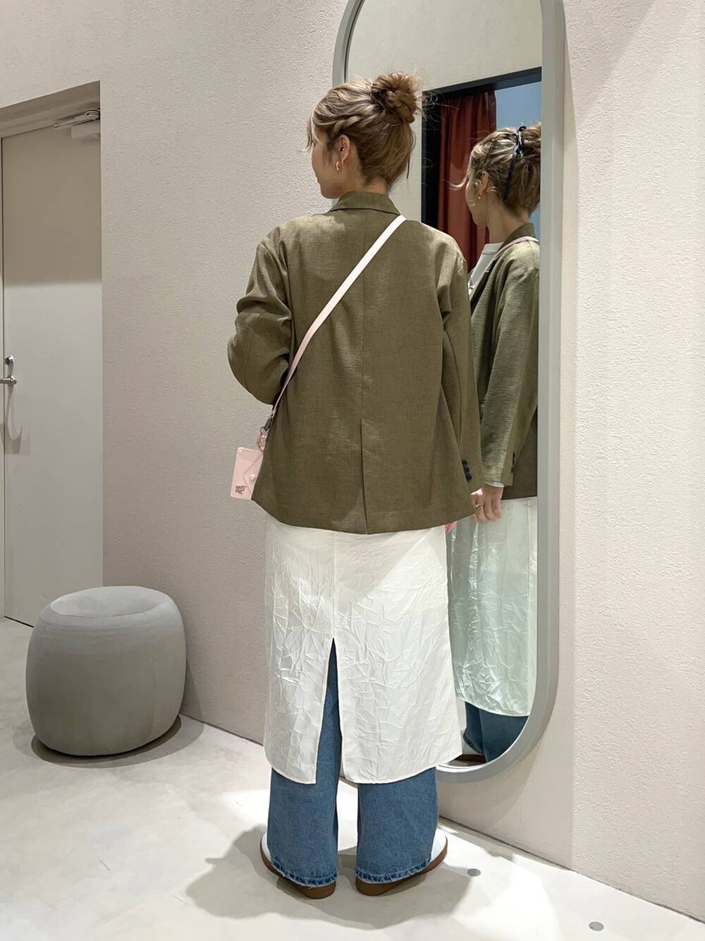 ホワイト系のTシャツ/カットソー、ブラウン系のテーラードジャケット、ブルー系のデニムパンツを着用したレディースの冬コーディネートの2枚目の写真