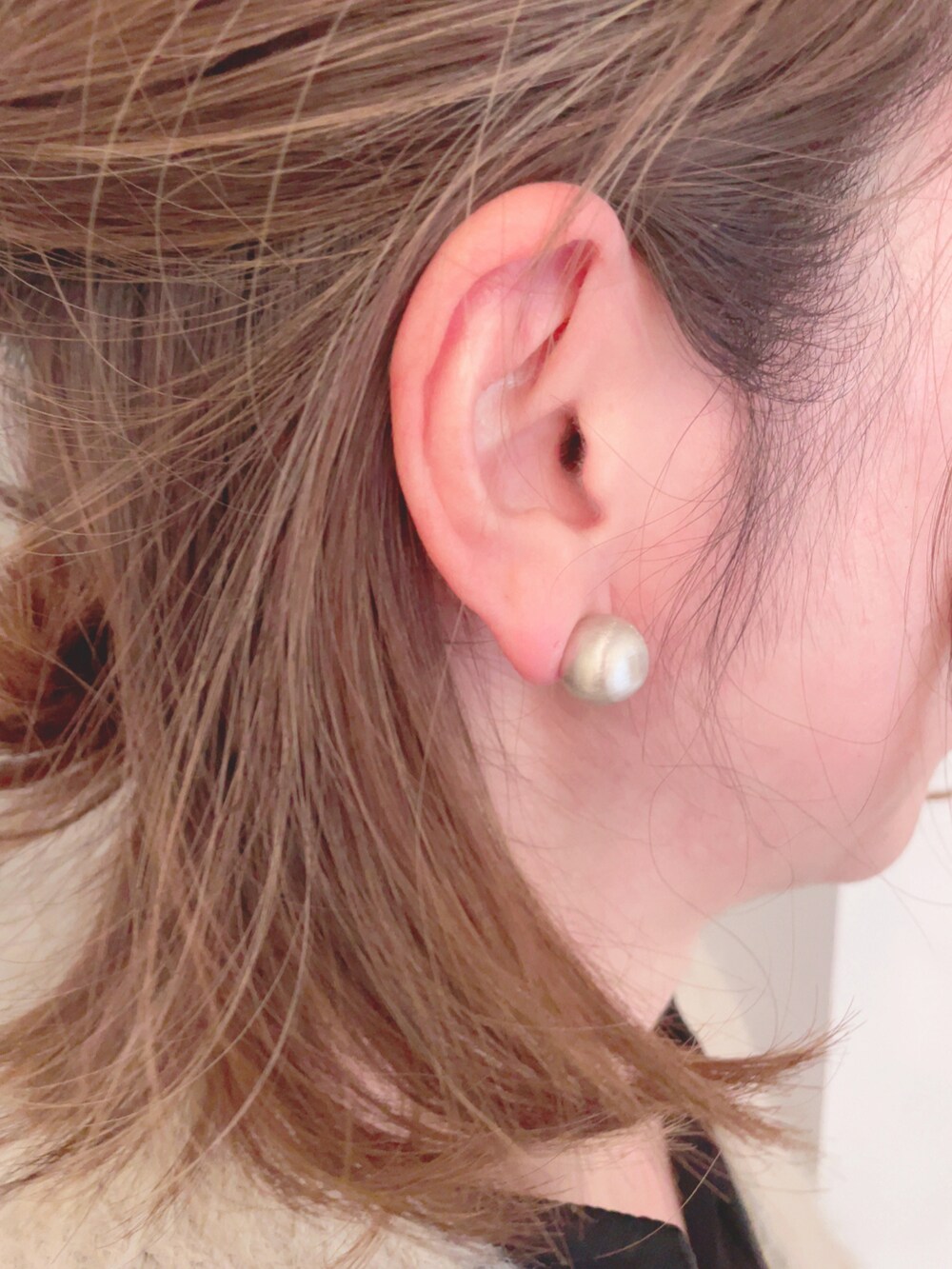 ベージュ系のカーディガン/ボレロ、ブラック系のワンピース、ブラック系のハンドバッグを着用したレディースの冬コーディネートの5枚目の写真
