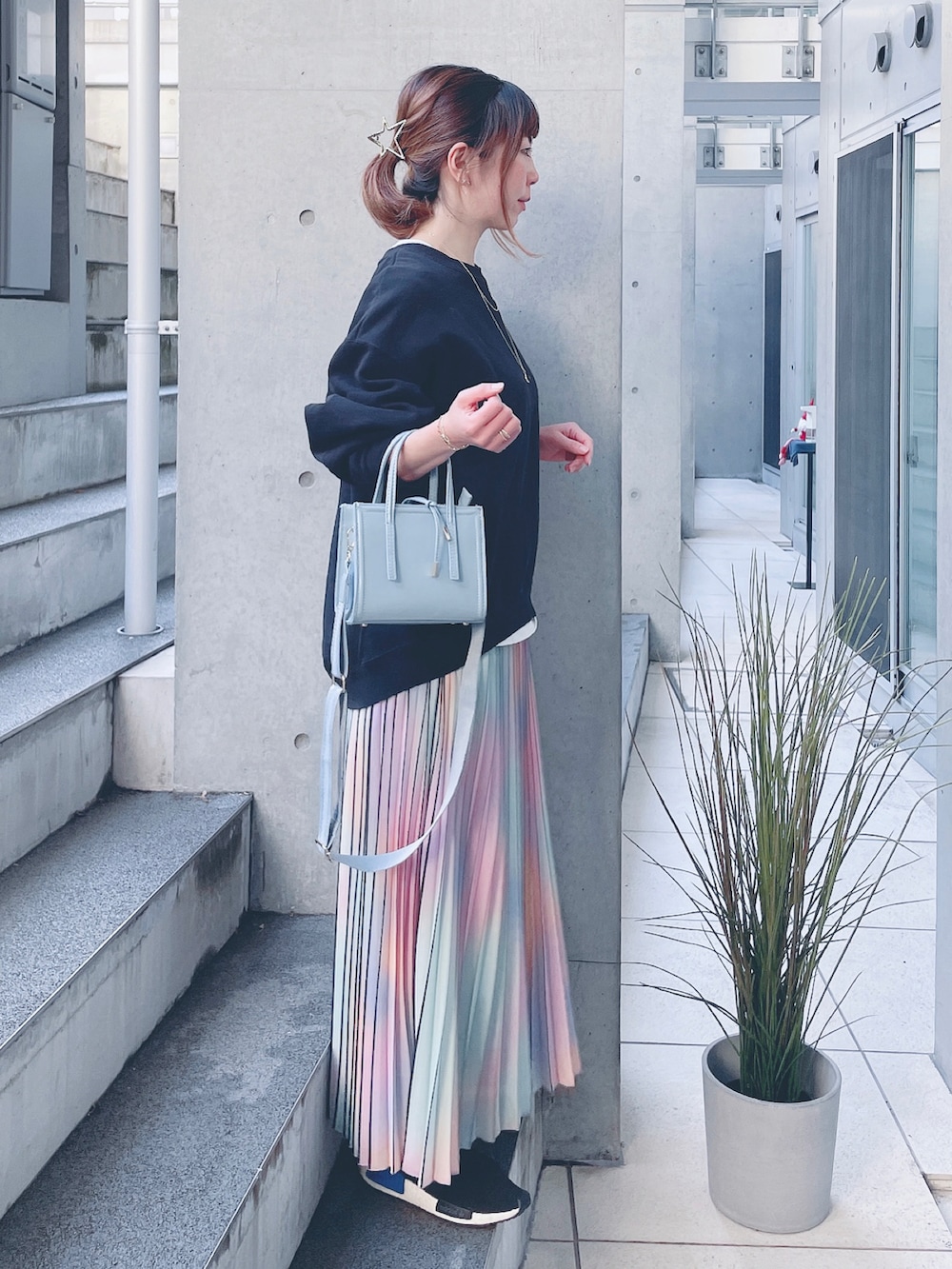 ブラック系のスウェット、ブルー系のショルダーバッグ、その他のスカートを着用したレディースの冬コーディネートの2枚目の写真