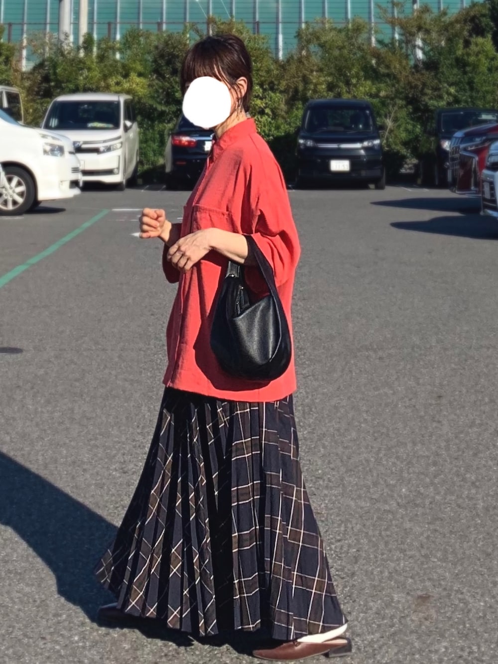 ブルー系のスカート、レッド系のシャツ/ブラウス、ブラウン系のローファーを着用したレディースの秋コーディネートの2枚目の写真