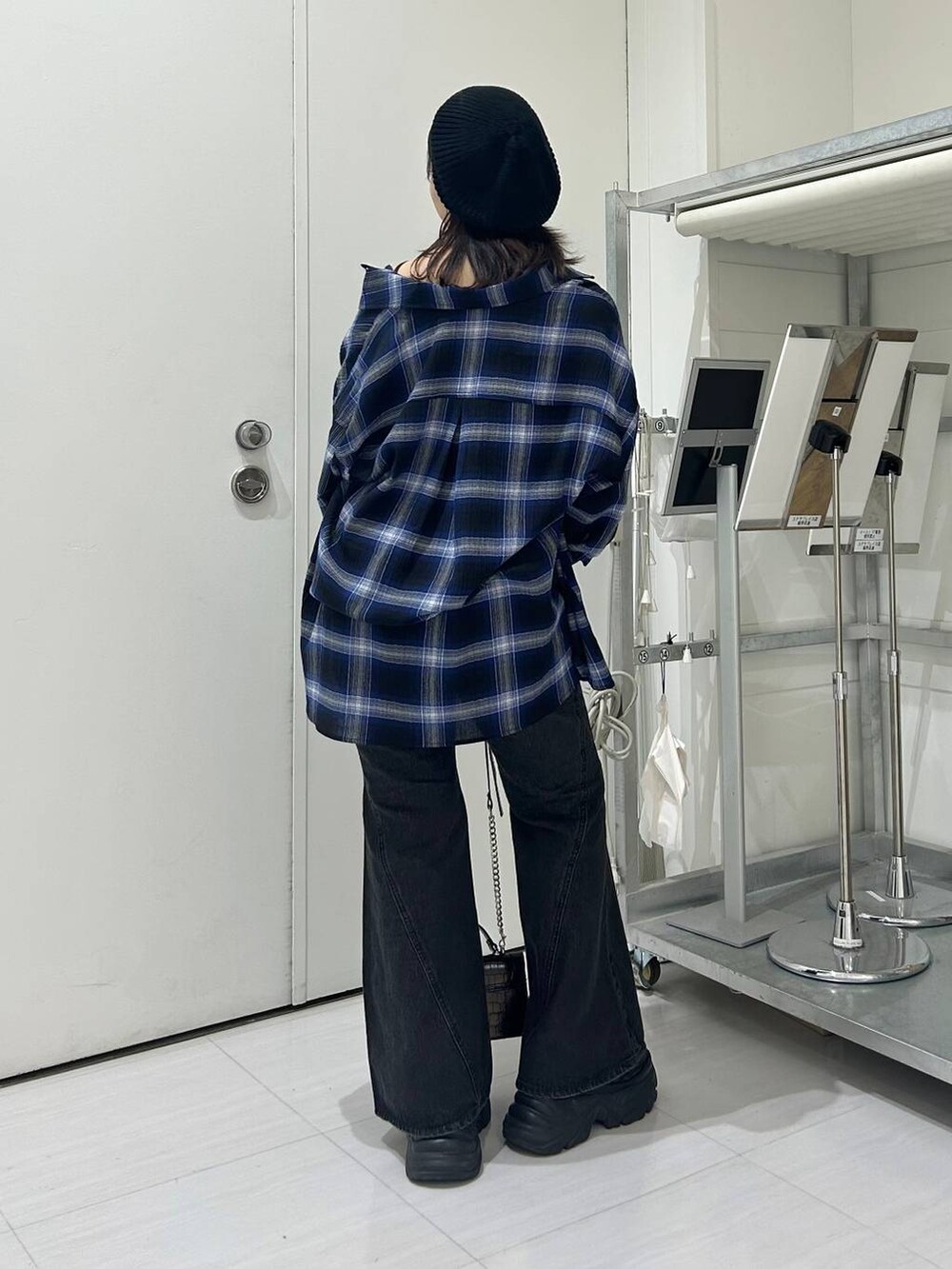 ブラック系のスニーカー、ブルー系のデニムパンツ、ブルー系のシャツ/ブラウスを着用したレディースの秋コーディネートの5枚目の写真