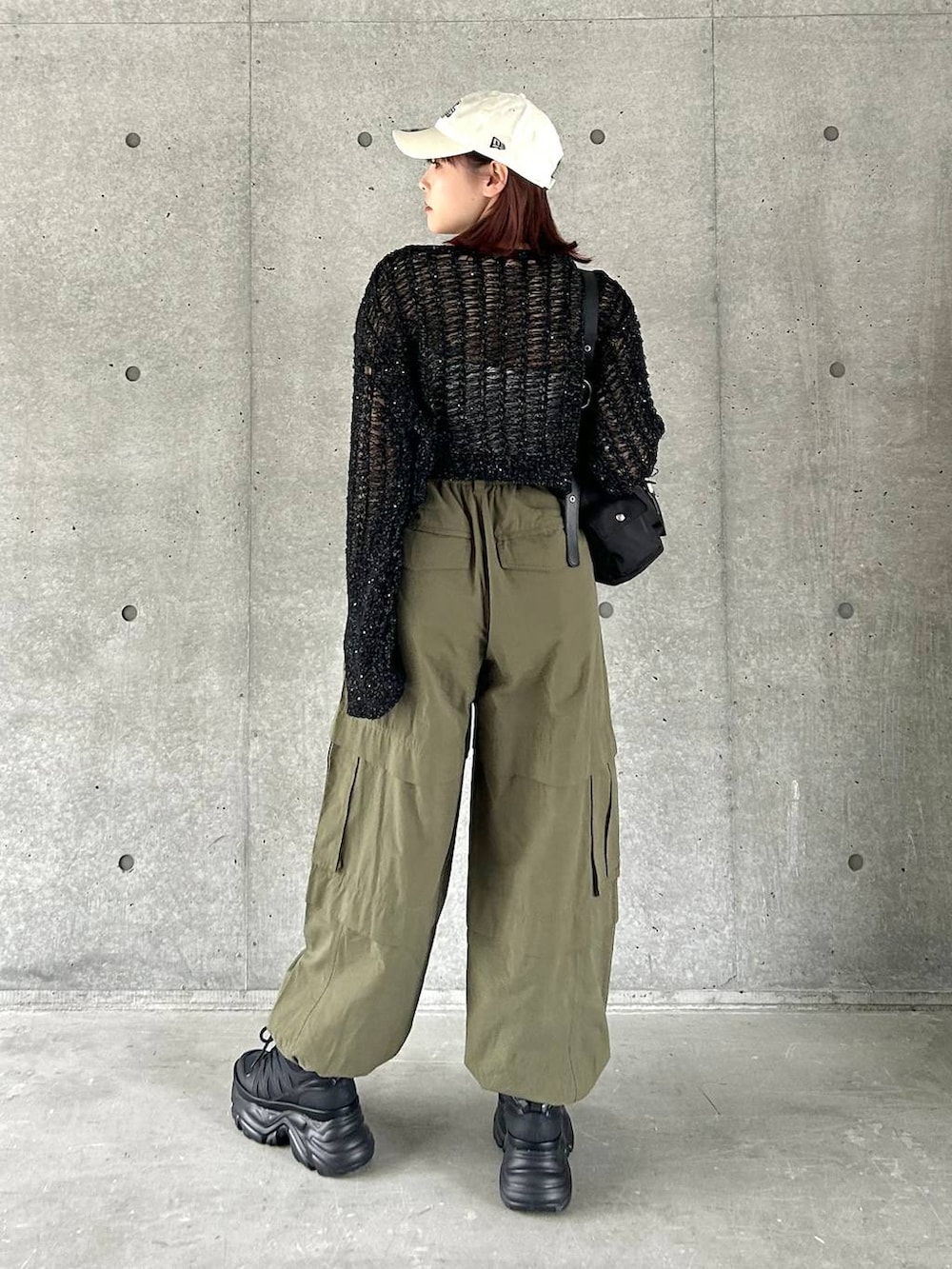 ブラック系のショルダーバッグ、ブラック系のスニーカー、グリーン系のその他パンツを着用したレディースの春コーディネートの5枚目の写真