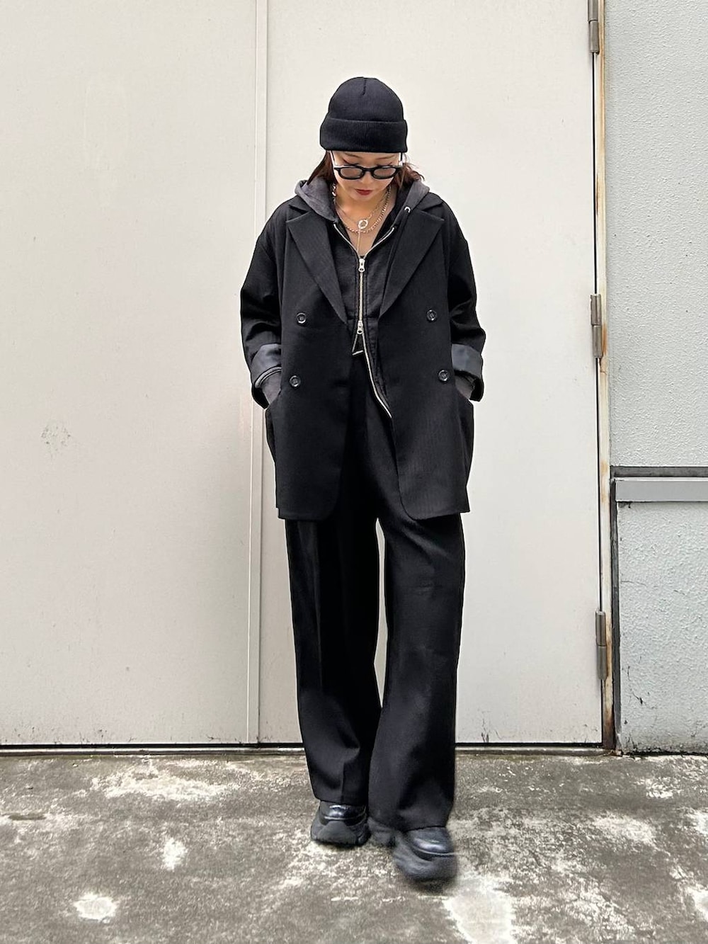 ブラック系のスニーカー、ブラック系のパーカー、ブラック系のテーラードジャケットを着用したレディースの秋コーディネートの4枚目の写真