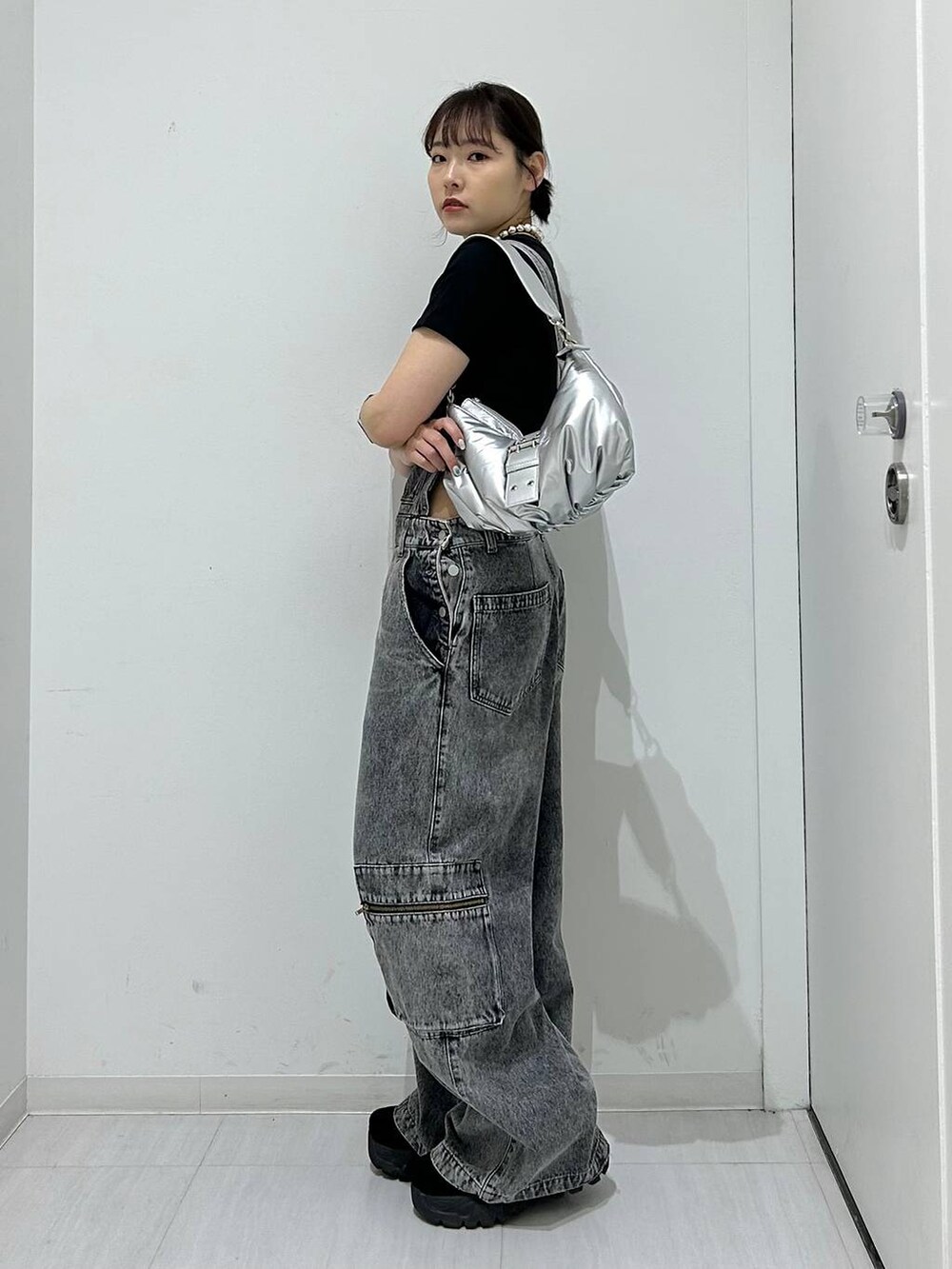 ブラック系のサロペット/オーバーオール、シルバー系のショルダーバッグ、ブラック系のTシャツ/カットソーを着用したレディースの夏コーディネートの5枚目の写真