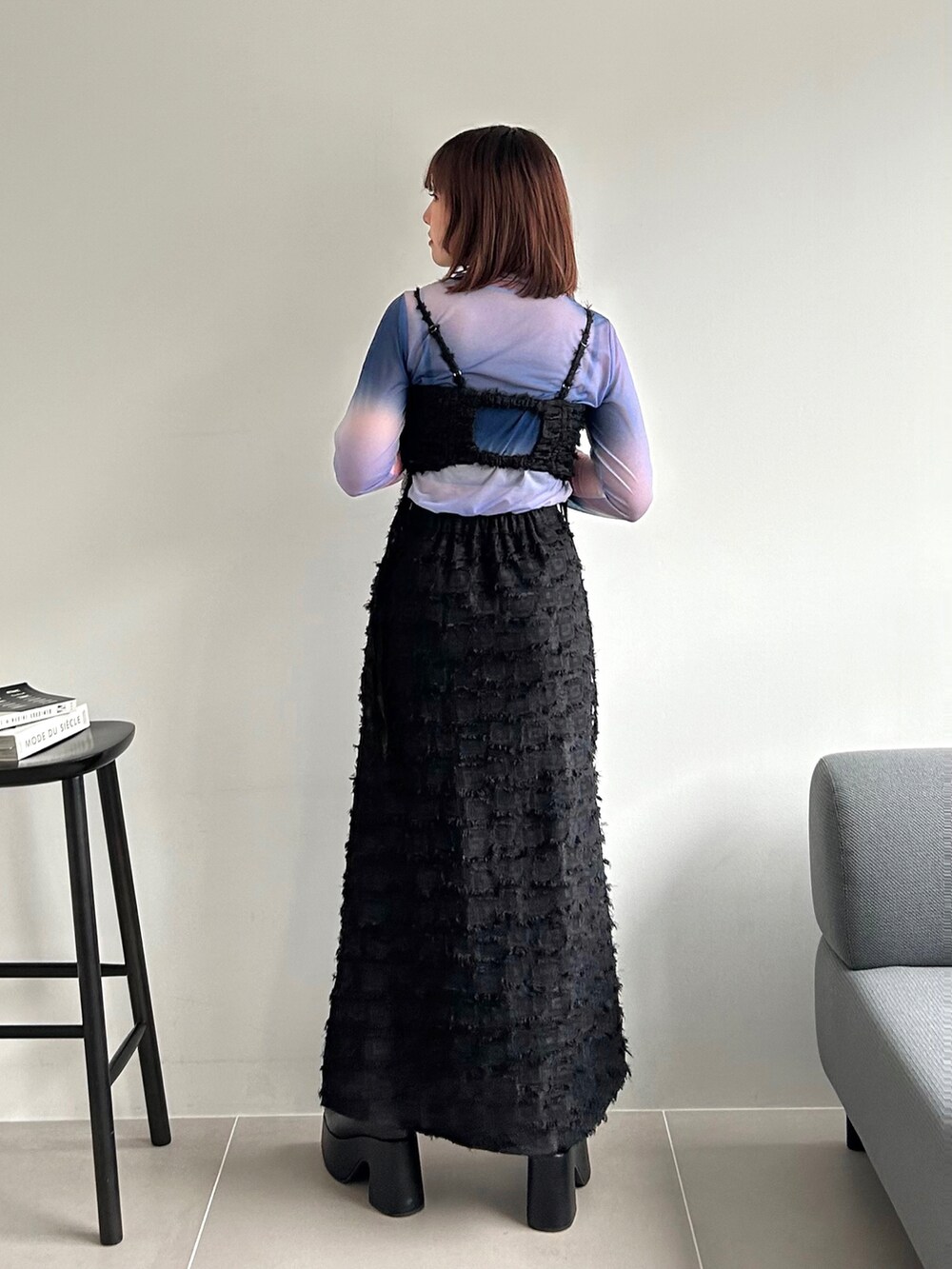 ブラック系のワンピース、ピンク系のTシャツ/カットソー、ブラック系のブーツを着用したレディースの秋コーディネートの5枚目の写真