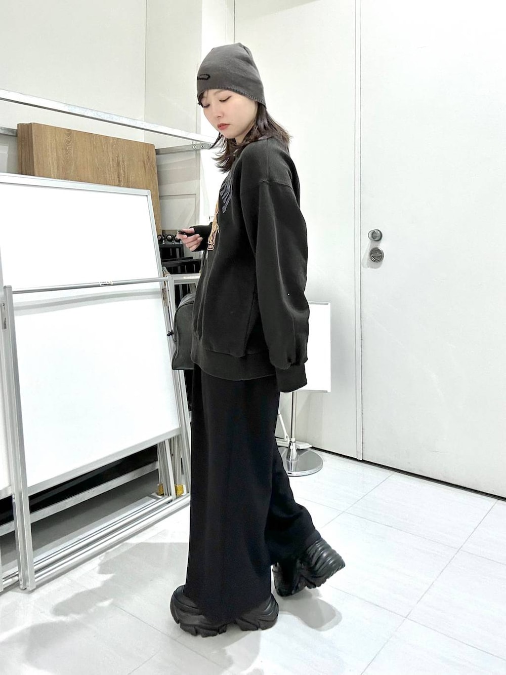 ブラック系のスニーカー、グレー系のボストンバッグ、グレー系のスウェットを着用したレディースの冬コーディネートの6枚目の写真