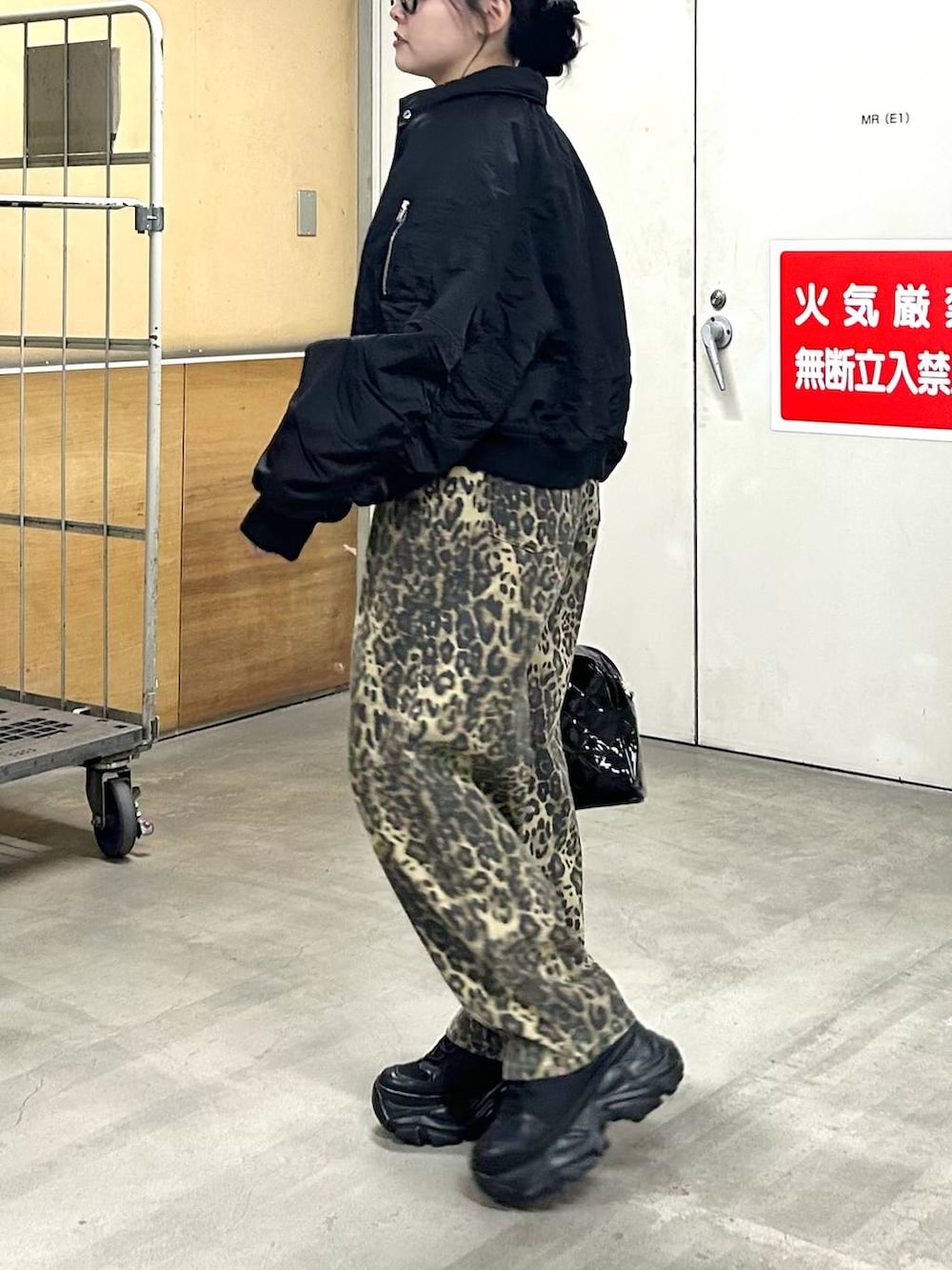 ブラック系のスニーカー、ブラック系のブルゾン、ブラック系のニット/セーターを着用したレディースの冬コーディネートの5枚目の写真