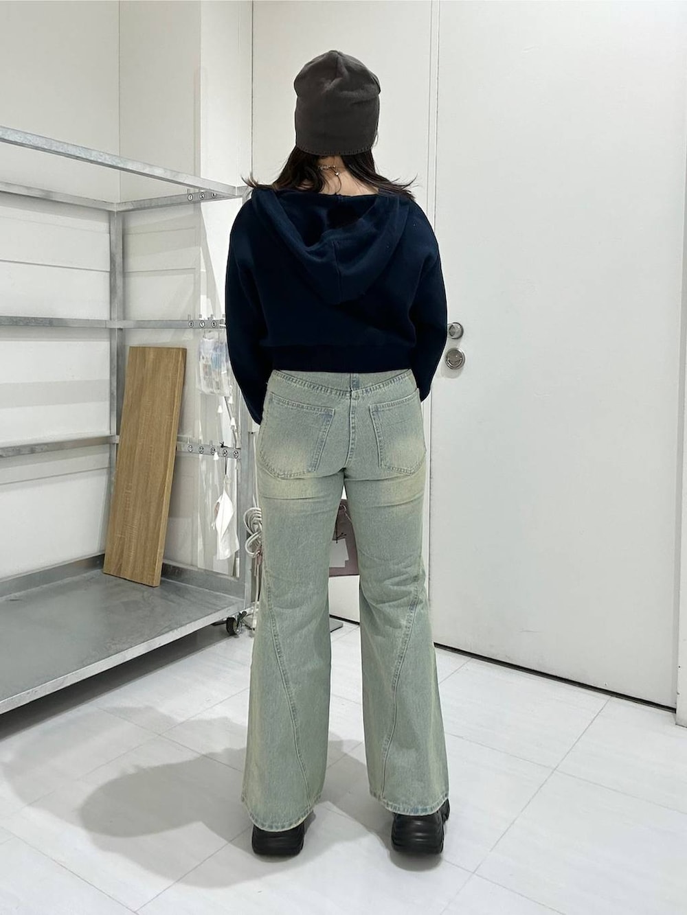 ブラック系のスニーカー、ブルー系のデニムパンツ、ブルー系のパーカーを着用したレディースの冬コーディネートの5枚目の写真