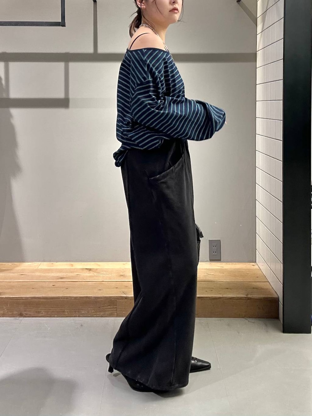 ブラック系のスウェットパンツ、ブラック系のショルダーバッグ、ブラック系のサンダルを着用したレディースの冬コーディネートの5枚目の写真