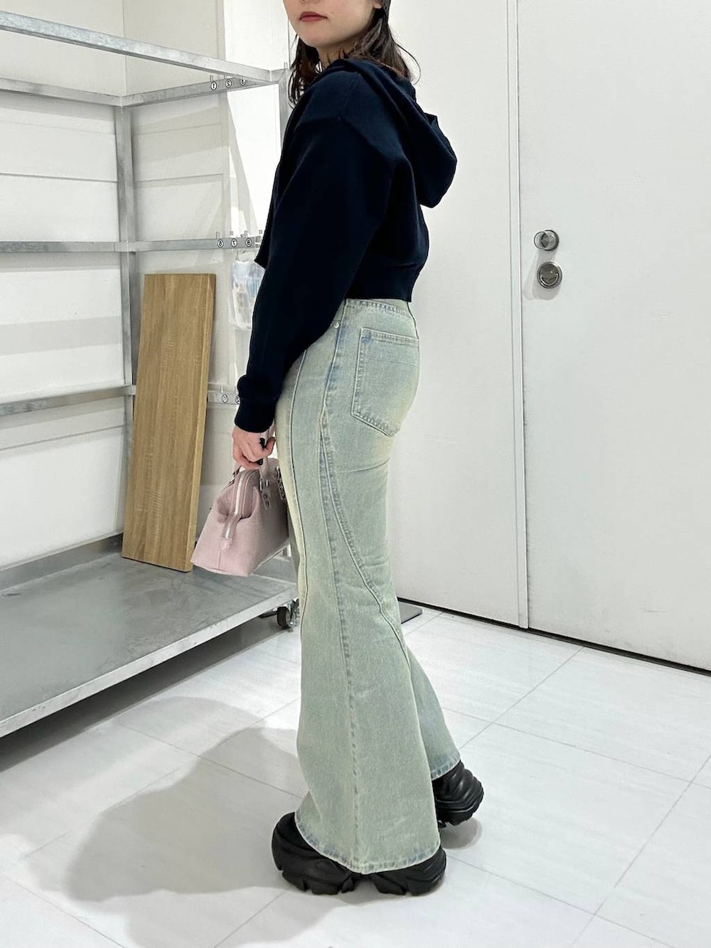 ブラック系のスニーカー、ブルー系のデニムパンツ、ブルー系のパーカーを着用したレディースの冬コーディネートの4枚目の写真