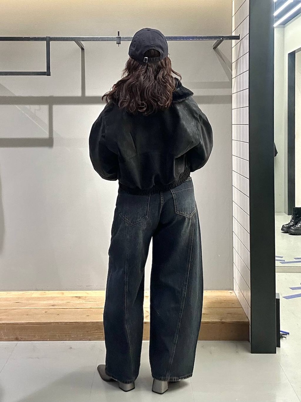 ブルー系のデニムパンツ、グレー系のTシャツ/カットソー、ブラック系のブルゾンを着用したレディースの秋コーディネートの6枚目の写真