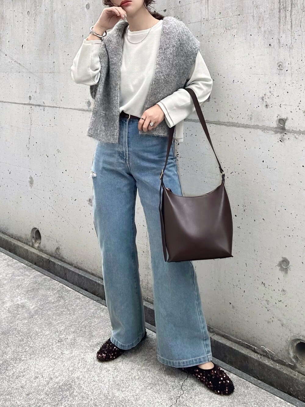 ホワイト系のニット/セーター、グレー系のニット/セーター、ブルー系のデニムパンツを着用したレディースの冬コーディネートの2枚目の写真