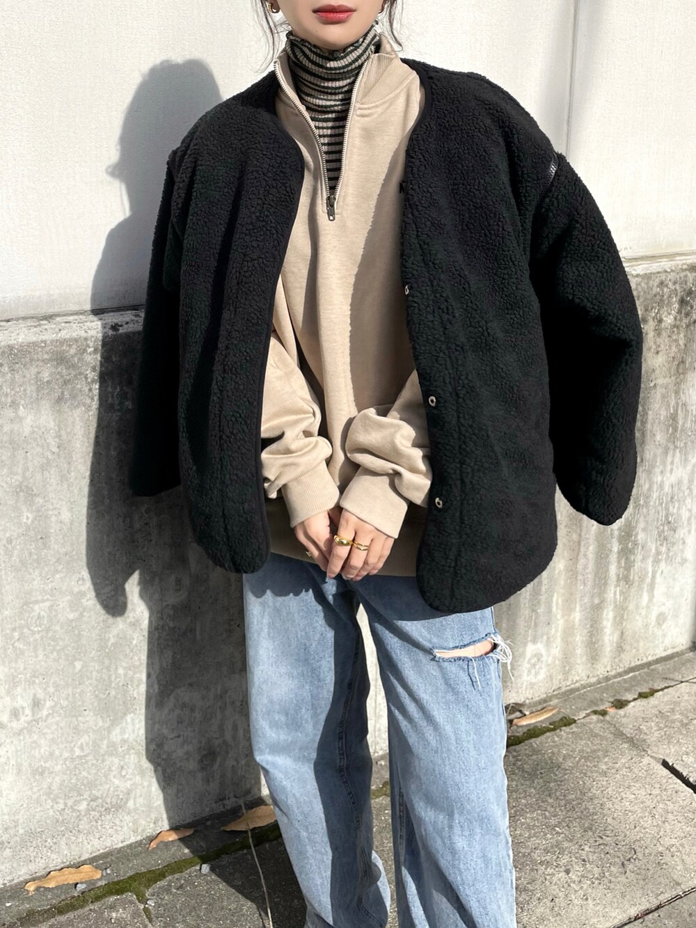 ブラック系のブルゾン、ベージュ系のスウェット、ベージュ系のニット/セーターを着用したレディースの冬コーディネートの2枚目の写真