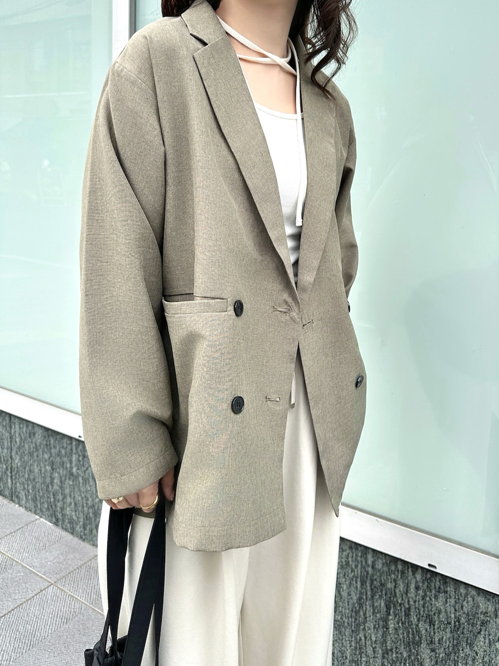 ブラウン系のテーラードジャケット、ホワイト系のTシャツ/カットソー、ホワイト系のスラックスを着用したレディースの春コーディネートの5枚目の写真