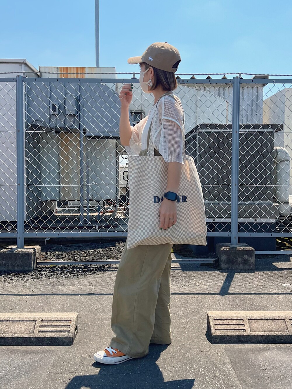 ベージュ系のトートバッグ、ベージュ系のサロペット/オーバーオール、オレンジ系のスニーカーを着用したレディースの夏コーディネートの2枚目の写真